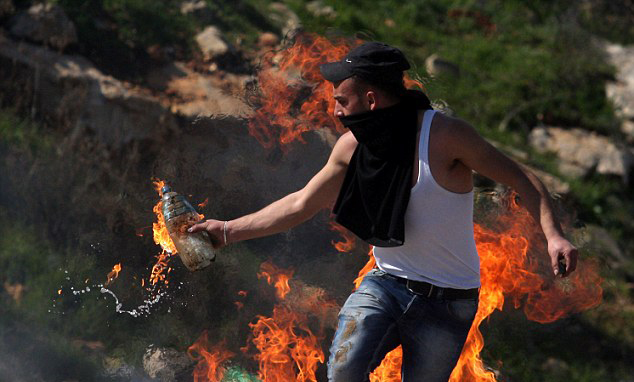 شاب فلسطيني يلقي زجاجة حارقة على قوات الاحتلال (أرشيف)